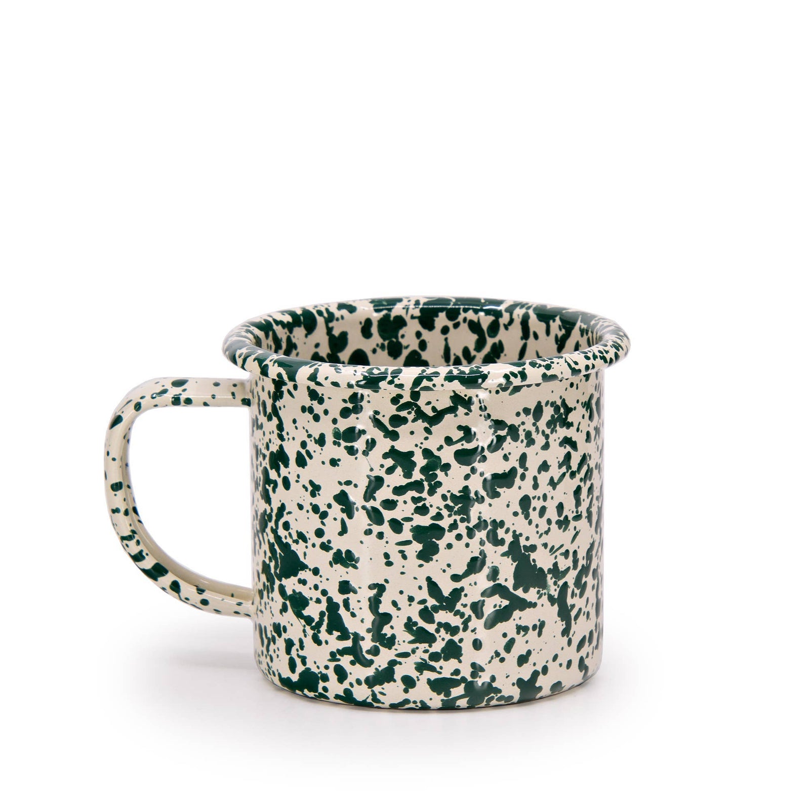 The Splatter Enamelware 12 oz Mug features a cream base with a green splatter pattern, large handle, and flared rim—perfect for adding charm to any colorful serveware collection. Shown on a plain white background.
