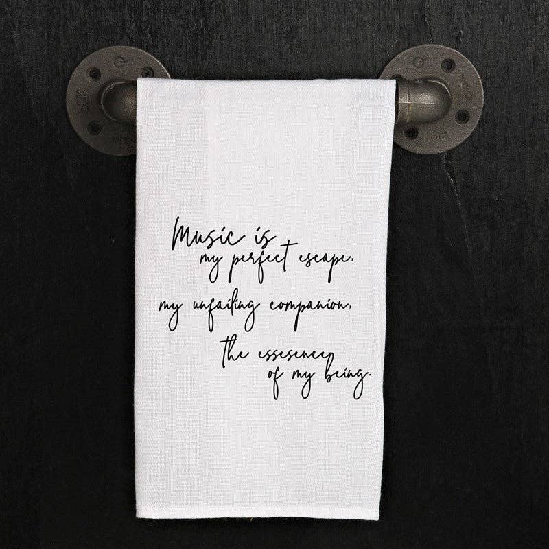 A 100% cotton towel hanging on a black wall with the text: "Music is my perfect escape," my unfailing companion, the essence of my being.