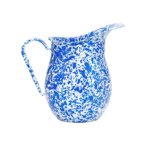 The Splatter Enamelware Large Pitcher, adorned with a vibrant blue and white splatter pattern, features a curved handle and wide spout, and is displayed on a plain white background. This 3 qt pitcher adds both charm and functionality to any table setting.