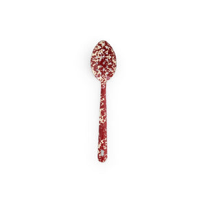 A Splatter Enamelware Large Slotted Spoon, featuring a red background with a white splatter pattern, is centered on a white background.