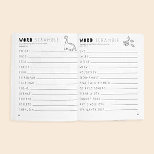 Open workbook showing two pages from "Gratitude For Kids (Mindfulness Activity Book for Kids)," featuring word scramble puzzles with answer spaces and cute dinosaur and leaf illustrations—ideal for kids who enjoy fun mindful activities.