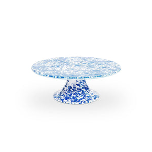 The Splatter Enamelware Cake Stand, featuring a vibrant blue and white speckled design with a round top and wide base, is perfect for entertaining.