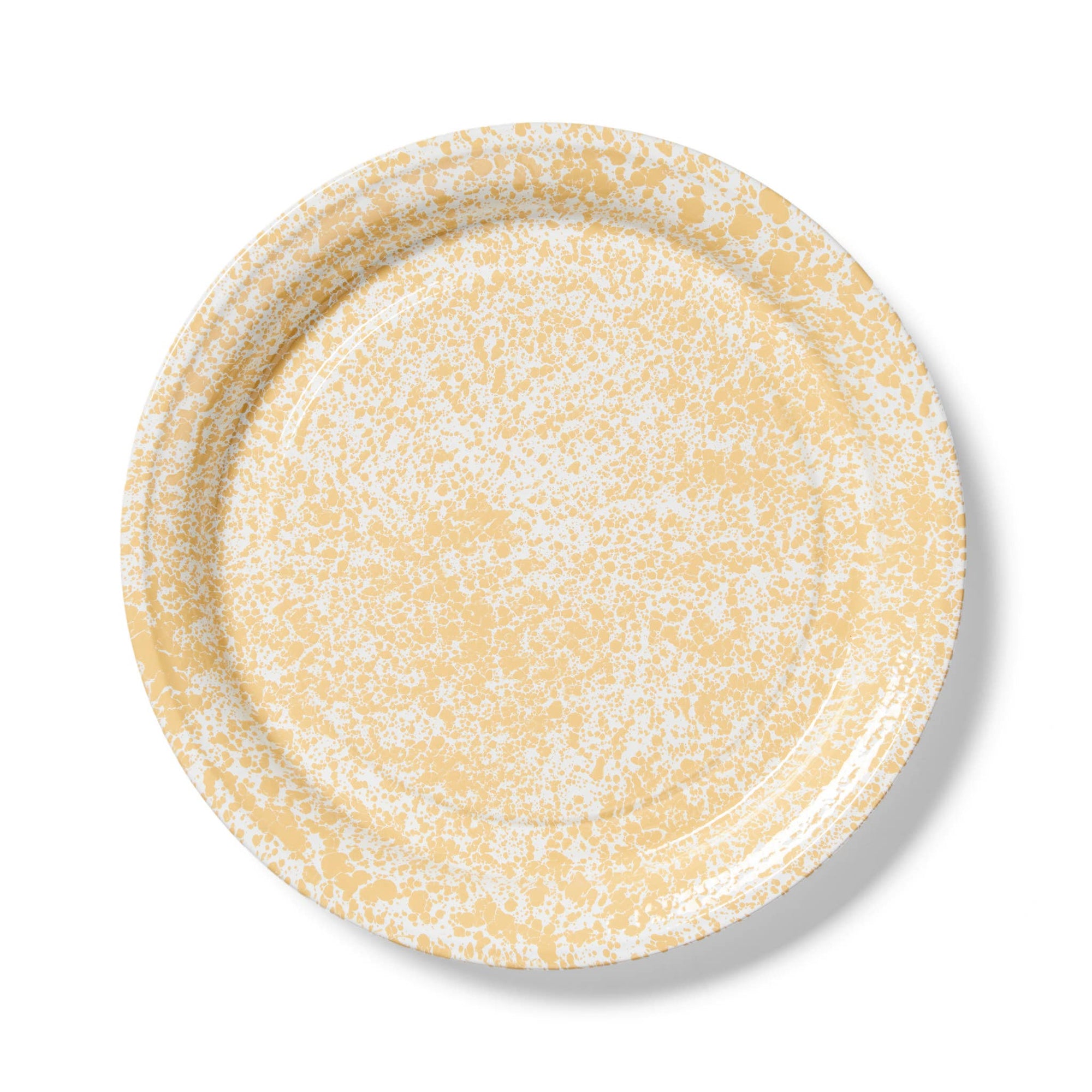 A Splatter Enamelware Large Round Tray featuring a yellow speckled design and a slightly raised rim, viewed from the top.