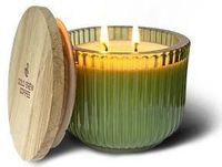 The Cathedral Glass Bowl Swan Creek Candle features a green ribbed glass jar with a wooden lid beside it and two lit wicks.
