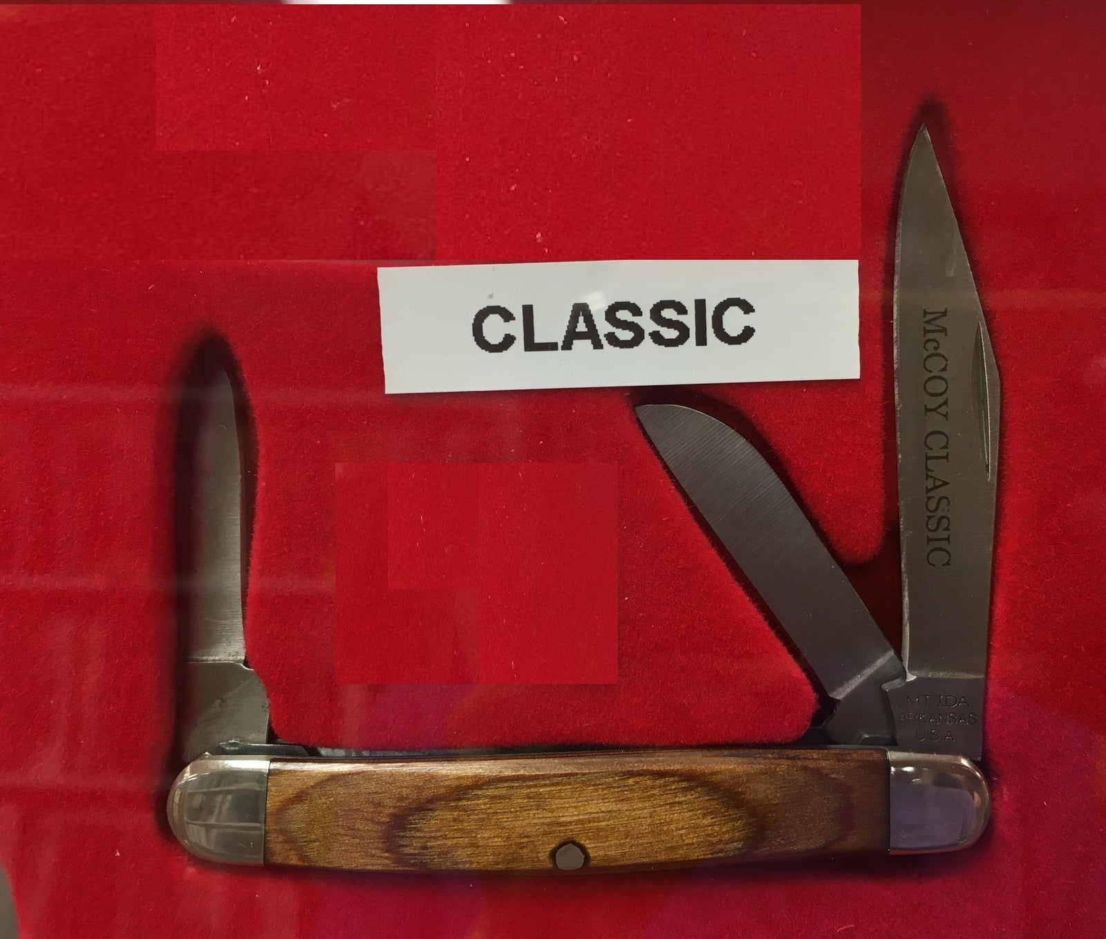 A knife with a zebra wood handle and McCoy Classic blades.