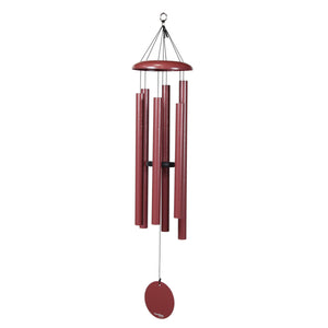 The Corinthian Bells® 44-inch Windchime, in red, features multiple tubes and a circular sail hanging from a central ring to create soothing tones, adding depth to serene settings.