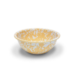 The Splatter Enamelware 20 oz Cereal Bowl, featuring a vibrant yellow and white splatter pattern, is perfect for colorful enamelware collections and is displayed on a white background.