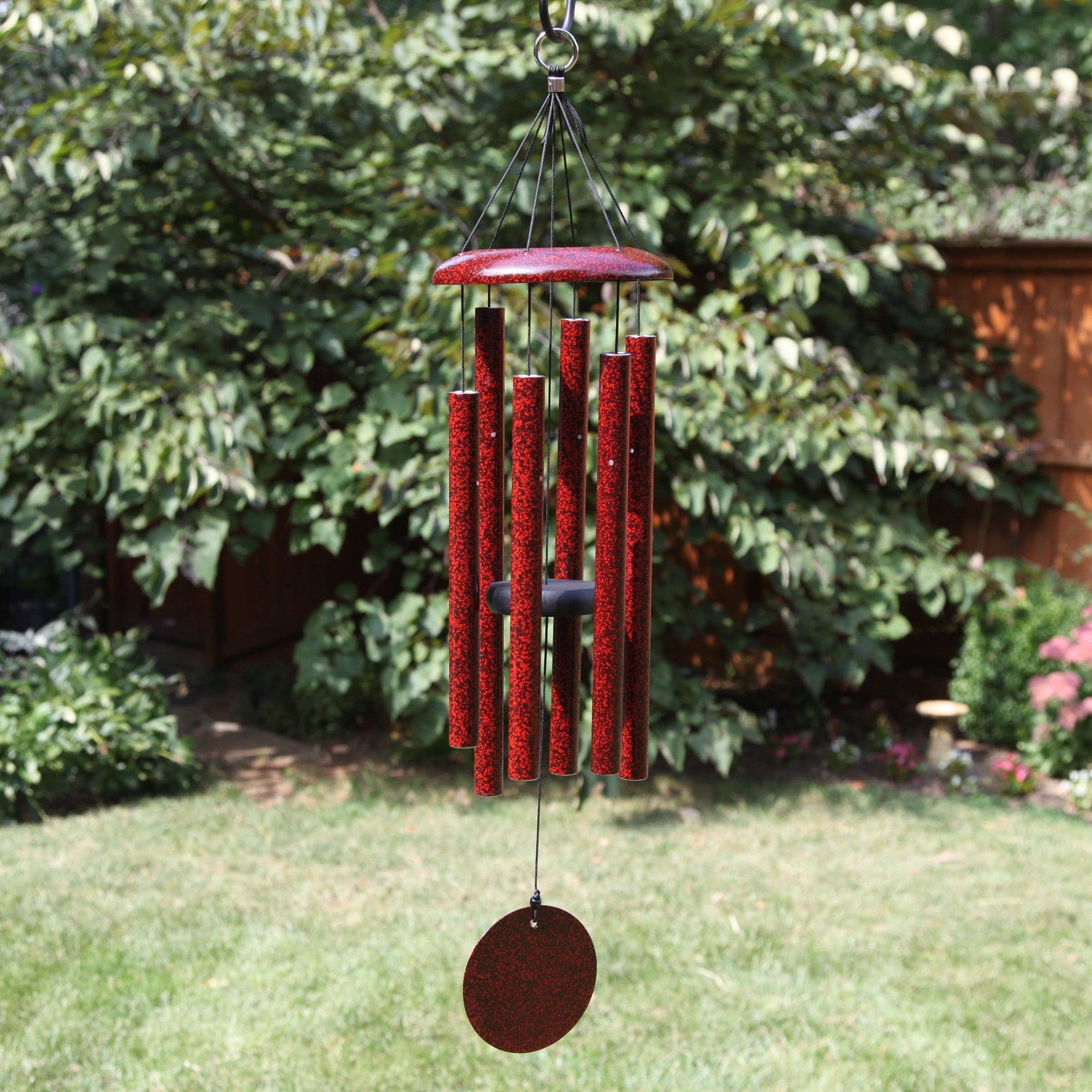 A Corinthian Bells® 30-inch Windchime hanging on a small patio.