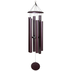 The Corinthian Bells® 60-inch Windchime boasts a stunning dark purple finish, with cylindrical tubes hanging from a circular top piece and featuring a round windcatcher at the bottom, all tuned to a soothing major 7th chord.