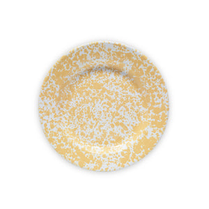 The Splatter Enamelware Dinner Plate features a white background adorned with a vibrant yellow speckled pattern, making it an ideal choice for colorful entertaining.