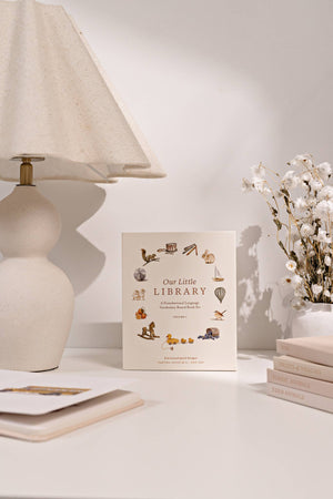 A vibrant board book featuring flowers on a desk with a lamp, perfect for teaching first words and expanding vocabulary, Our Little Library is ideal.