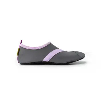 A minimalist black and gray slip-on shoe with a pink stripe, designed with a low profile and a small yellow tag at the heel. This Women's Classic FITKICKS is perfect for active footwear.