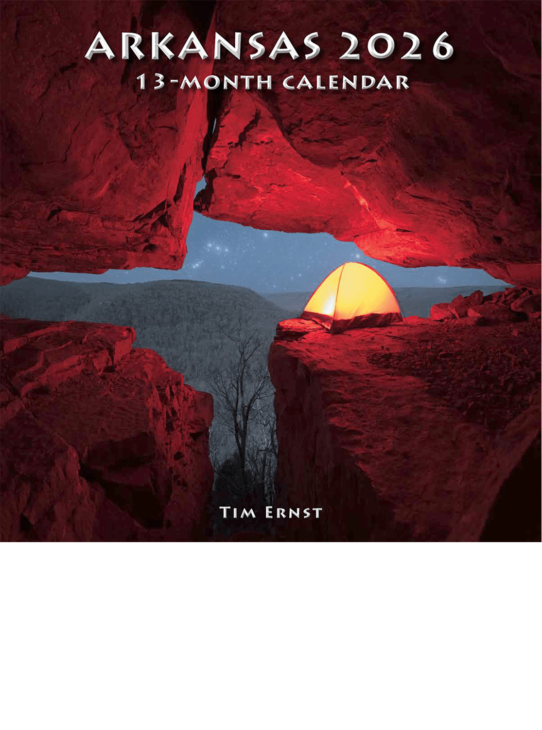 A glowing tent is pitched beneath a rock overhang at night with stars overhead. Text displays "2026 Arkansas Tim Ernst Wall Calendar.