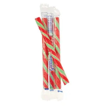Three Gilliam's Stick Candy canes—striped in red, green, and white—are shown in a partially opened clear plastic wrapper, with one stick broken in half.
