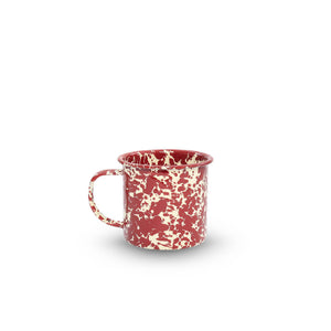 The Splatter Enamelware 12 oz Mug, featuring a red and white speckled design and handle, is shown on a plain white background.