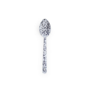 The Splatter Enamelware Large Slotted Spoon, featuring a classic black and white speckled pattern, is centered on a white background.