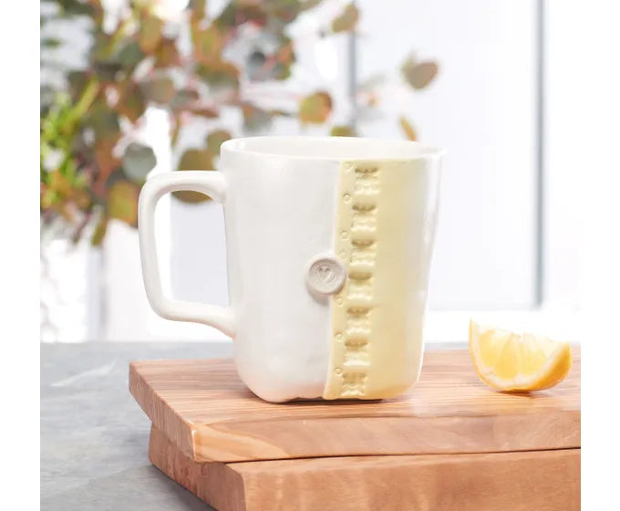 A ceramic mug from the Studio M Coffee Mugs collection, adorned with a lemon.