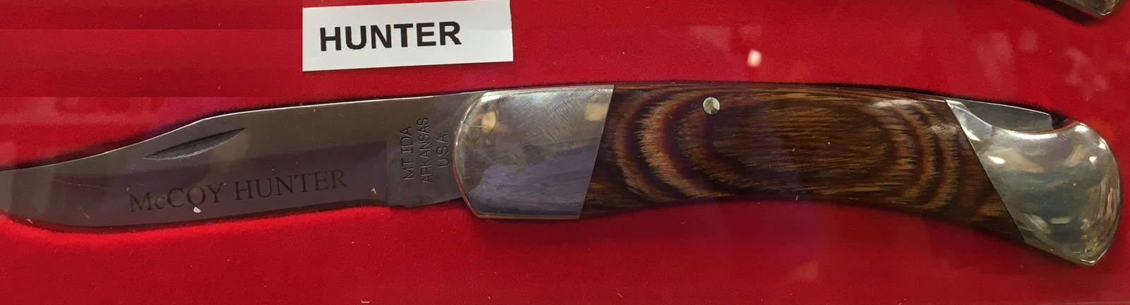 A McCoy Hunter-HW lock back knife with the words hunter on its handle and a heritage walnut grip.