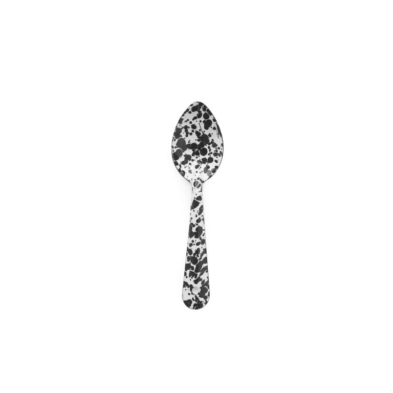 The Splatter Enamelware Medium Spoon, featuring a distinctive black and white speckled pattern, is centered on a plain white background—ideal for serving or entertaining.