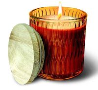 A Chestnut Glass Medium Tumbler Swan Creek Candle glows in a textured glass jar with a wooden lid set beside it.