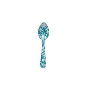 The Splatter Enamelware Medium Spoon, featuring a turquoise and white splatter design, is centered on a white background—perfect for adding color to your serveware collection.