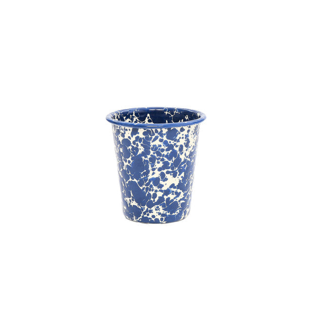 The Splatter Enamelware 10 oz Short Tumbler features a blue and white splatter pattern and is perfect for stylishly serving drinks. Shown on a plain white background, it's a unique addition to your tumbler collection.