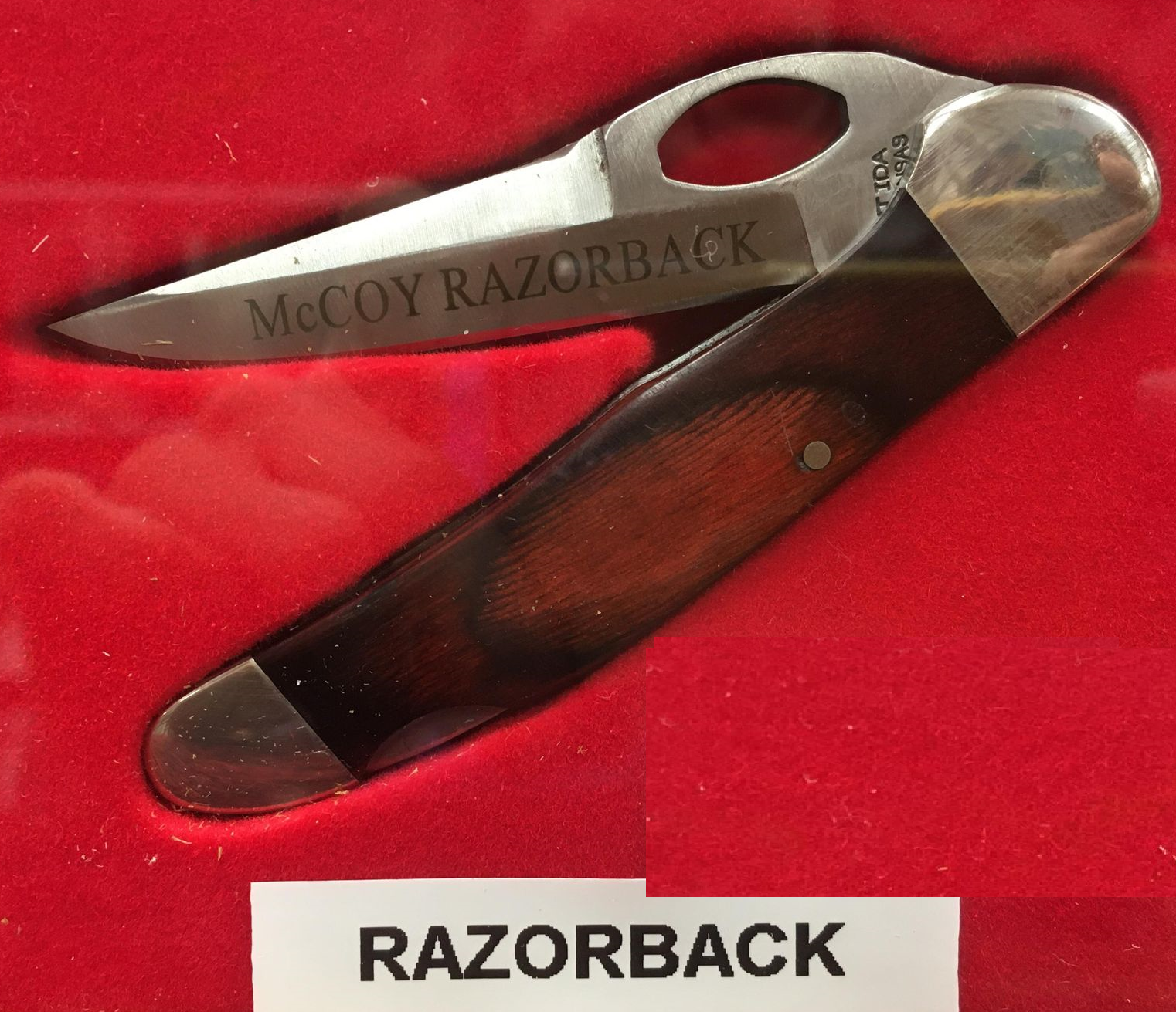 A McCoy Razorback knife with a rosewood handle engraved with the words "McCoy".