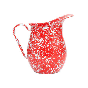 The Splatter Enamelware Large Pitcher features a vibrant red and white speckled design, a curved handle, and a wide spout. Combining charm with durability, this colorful pitcher holds up to 3 quarts and is shown against a plain white background.