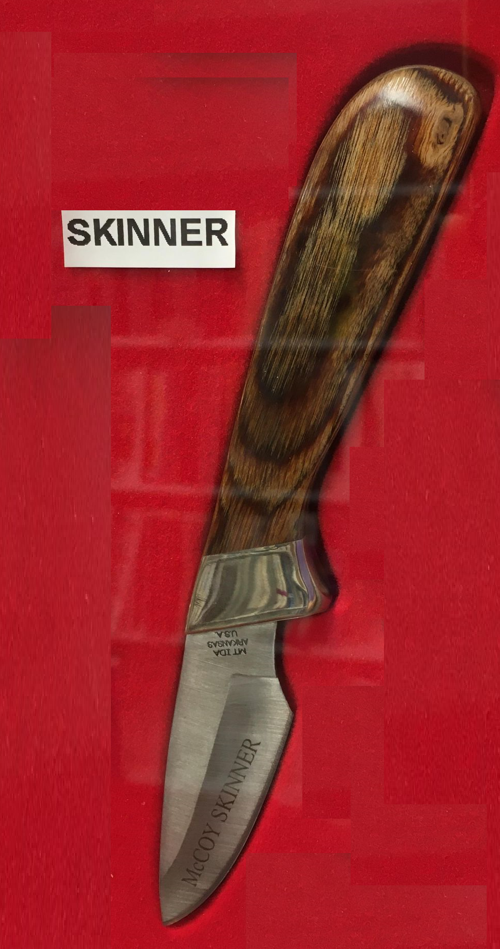 A McCoy Skinner-HW with the word skinner on its handle and a drop point blade.