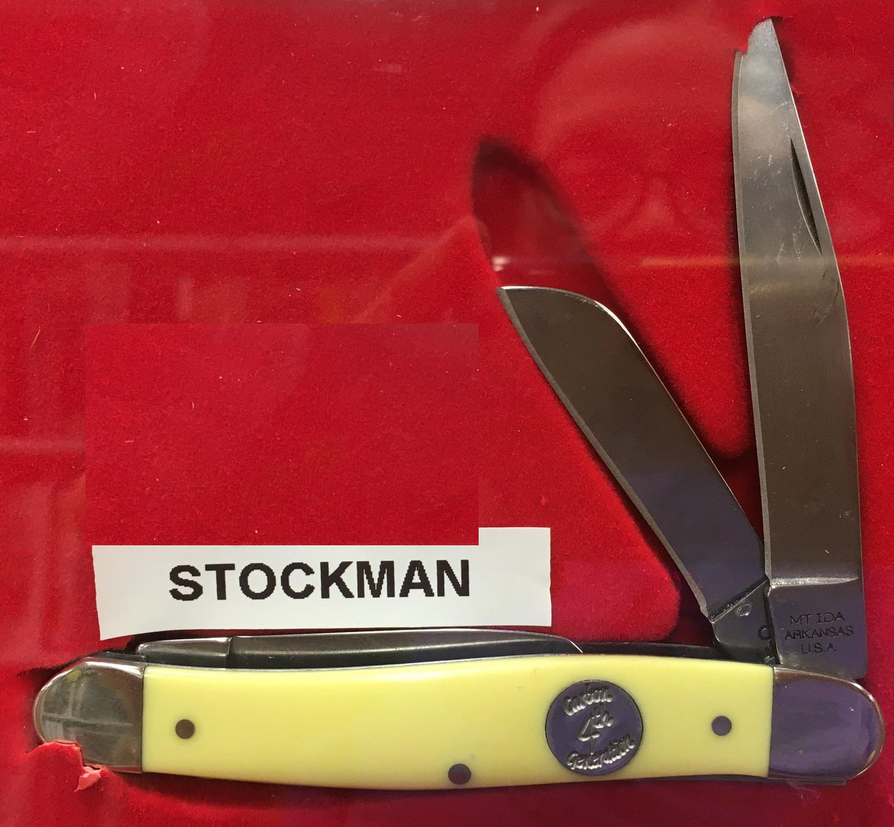 A yellow Delrin handle McCoy Stockman knife with 3 carbon blades in a red box.