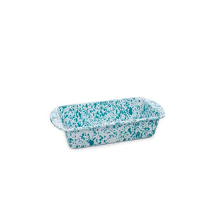 The Splatter Enamelware Loaf Pan, designed with a blue and white speckled enamelware pattern and two handles, is displayed against a plain white background.