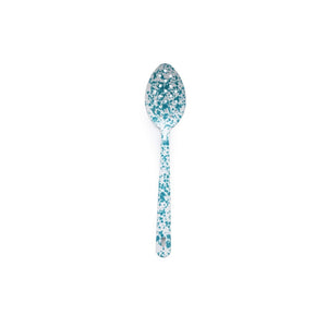 The Splatter Enamelware Large Slotted Spoon, featuring a white handle and bowl adorned with blue speckled patterns evocative of classic enamelware, is centered against a plain white background.