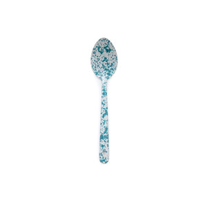 The Splatter Enamelware Large Serving Spoon, featuring a blue and white splatter pattern, is centered on a white background—perfect for serving guests when entertaining.
