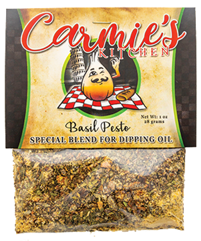 A 1 oz package of Pesto Dipping Oil Seasoning from Carmie's Kitchen features a logo with an illustration of a garlic bulb chef, and the basil pesto mix is visible at the bottom—ideal for enhancing olive oil or experimenting with any of Carmie's dip mixes.