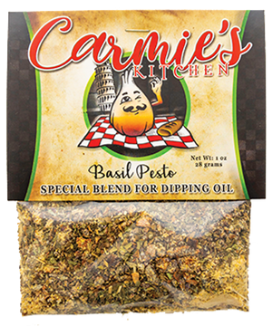 A 1 oz package of Pesto Dipping Oil Seasoning from Carmie's Kitchen features a logo with an illustration of a garlic bulb chef, and the basil pesto mix is visible at the bottom—ideal for enhancing olive oil or experimenting with any of Carmie's dip mixes.