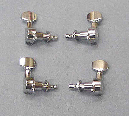 Four small, metallic, L-shaped chrome tuning pegs are arranged in a square pattern on a gray background, reminiscent of the precision found in Gotoh angle valves.