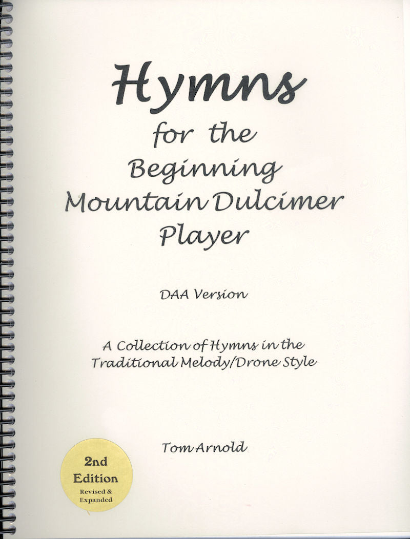 Cover of a spiral-bound book titled "Hymns for the Beginning Mountain Dulcimer Player (DAA) by Tom Arnold." It is the 2nd edition, revised and expanded to include traditional melody/drone style arrangements for beginners.