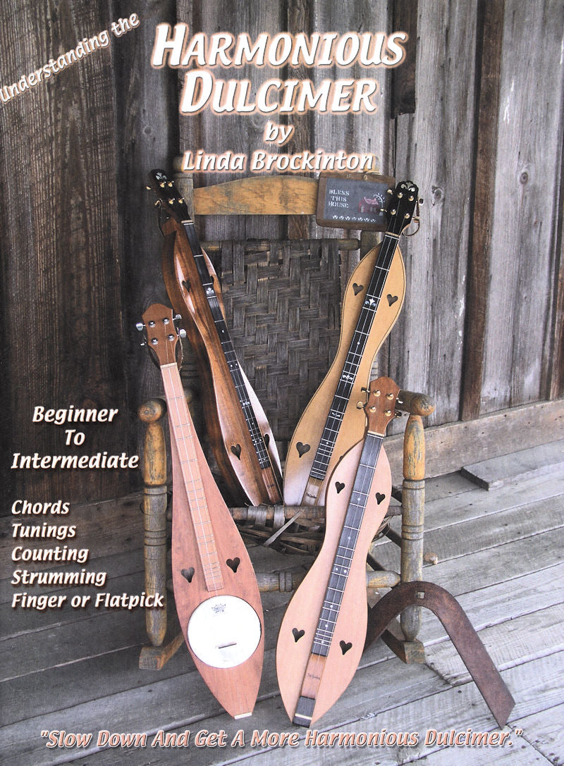 Image depicts a chair with five dulcimers resting against it. The book cover reads "Harmonious Dulcimer by Linda Brockinton," and includes the text, "Beginner to Intermediate, focusing on strumming techniques and mastering chords" along with other details.