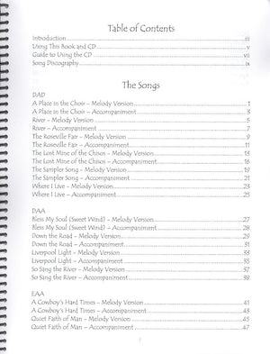 A spiral bound notebook with text containing melody and chord tablature by So Sang the River - by Heidi Muller.