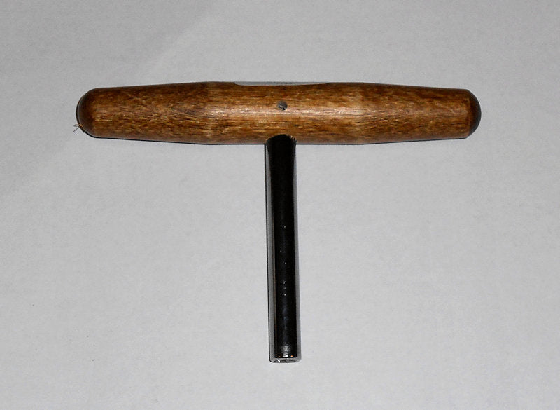 A wooden tool with a black handle for T' Shape Wrench on a white surface.