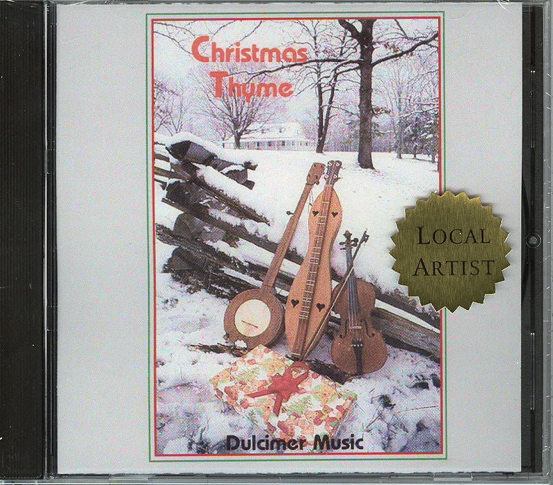 The CD cover titled "Christmas Thyme" by Jean Jennings and local artist Pam Kirby Setser features string instruments and a wrapped gift in the snow. Jean Jennings's seasonal artwork beautifully captures the festive spirit on this CD.