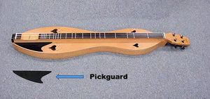 A wooden Appalachian dulcimer with heart-shaped sound holes rests on gray carpet; a black Pickguard-Right Sided and an arrow labeled “Pickguard” are displayed in the foreground, highlighting this essential accessory for any right-handed dulcimer player.