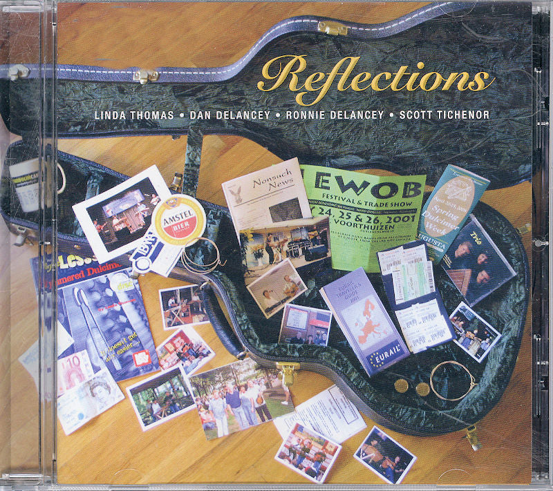 A guitar case that is open and full of various stickers, flyers, photographs, and a CD titled "Reflections" by Linda Thomas, featuring contributions from Dan Delancey, Ronnie Delancey, and Scott Tichenor.