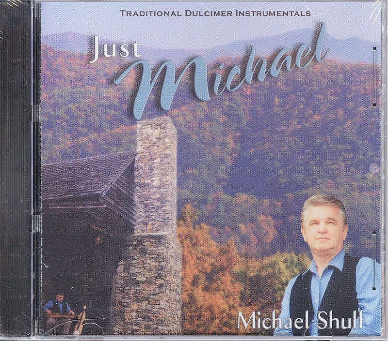 CD cover titled "Just Michael" by Michael Shull, featuring traditional mountain dulcimer instrumentals. The image displays a man in a vest standing in front of a stone building with autumn trees in the background.