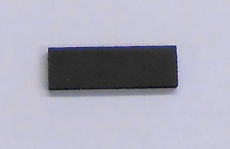 A small black square with a Capo Insert For Use with 6 String Dulcimers on a white surface.