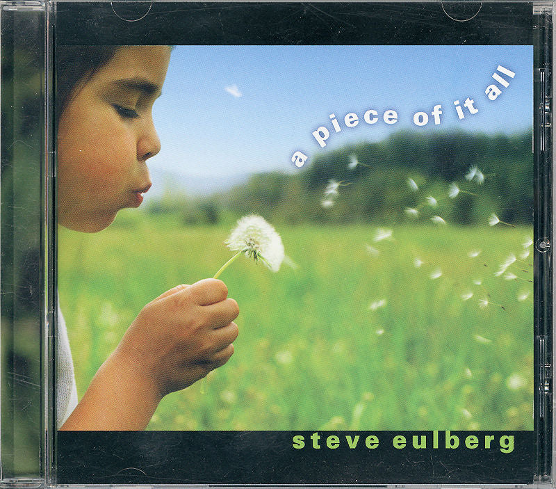 In a lush green field, a child blows on a dandelion, accompanied by the text "A Piece of It All by Steve Eulberg.