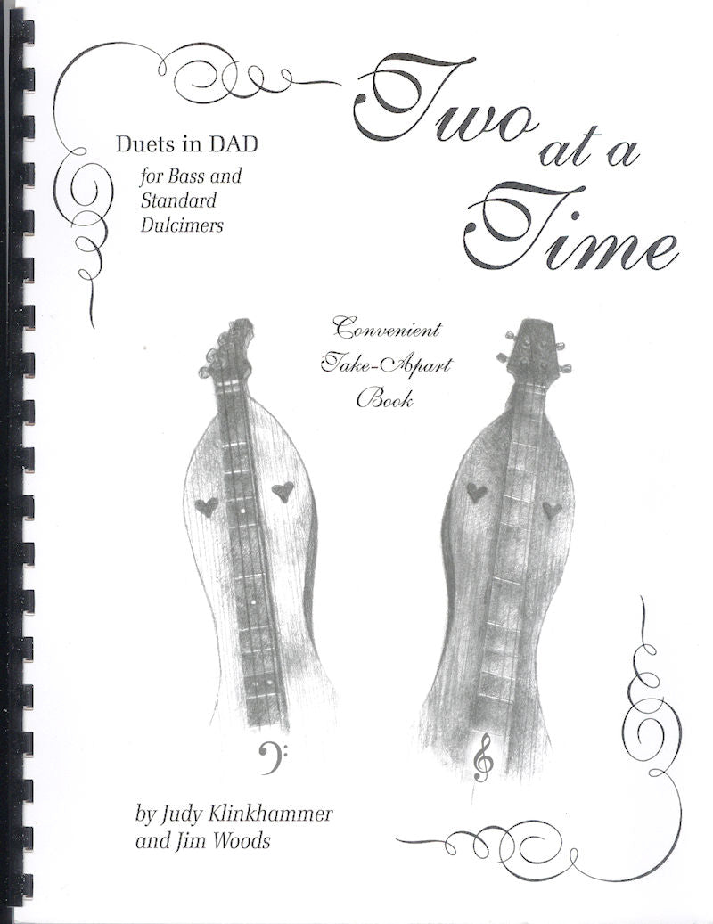 Cover of "Two at a Time" by Judy Klinkhammer and Jim Woods, featuring duets for bass dulcimer and standard dulcimer. The cover includes illustrations of two dulcimers along with musical symbols.