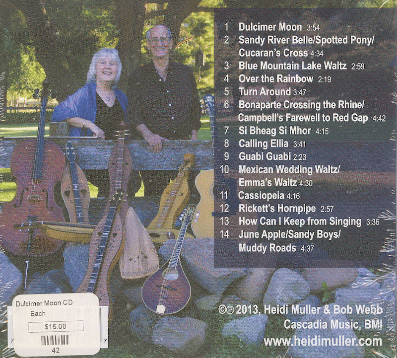 Bob Webb and Heidi Muller are pictured outdoors with an array of string instruments resting on a rock wall, accompanied by the CD tracklist for their album "Dulcimer Moon.