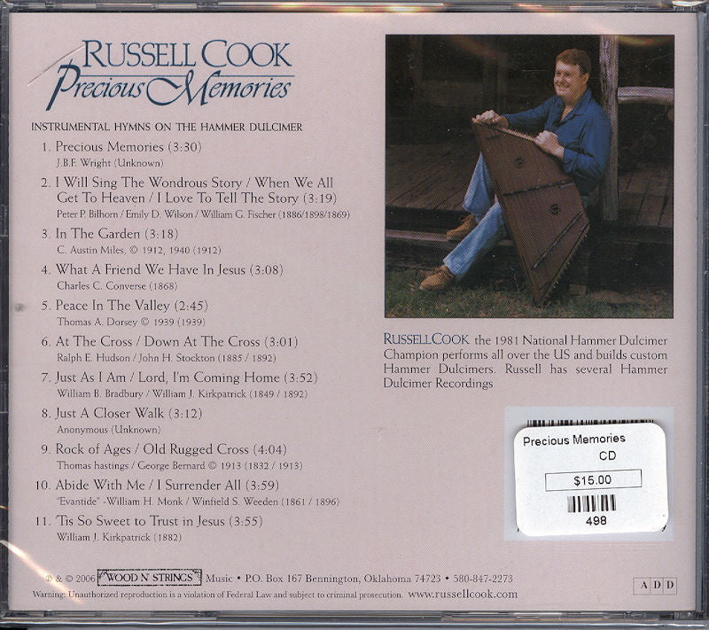 Precious Memories - by Russell Cook's CD cover prominently features an image of a man skillfully playing a guitar.