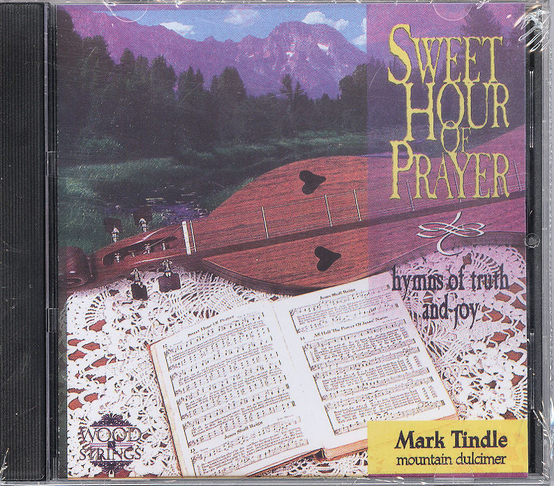 The CD cover features a mountain dulcimer resting on a lace-covered table alongside an open music book, set against a backdrop of mountainous scenery. The title "Sweet Hour of Prayer" by Mark Tindle is prominently displayed.